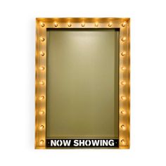 a lighted mirror with the words now showing on it