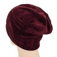 a mannequin's head wearing a maroon velvet beret, late 19th century