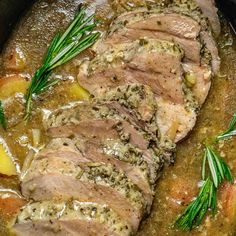 pork roast with potatoes and herbs in a pot