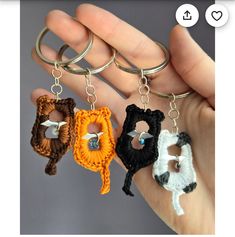 three crocheted keychains in the shape of animals are being held by someone's hand