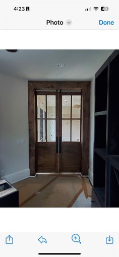 an empty room with two doors and windows