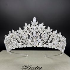 Transform into a dazzler on your special day with our elegant Tiara Crown. Perfect for brides and quinceañeras, this fashionable crown adds just the right amount of glamour without being overwhelming. Complete your look with this tasteful and exclusive accessory. High Quality Teardrop, Marquise and Round CZ gems. Measures 2 1/4 inches central height tapering to 1 inch to the sides Handcrafted with highest quality Zirconia jewels and rhodium plated to prevent tarnish and scratch. Ideal for Wedding, Bridal Hair, Anniversary, Quinceanera, Prom, Pageant and Special Occasions. Each Lucky Collections ™ tiara comes in custom luxury box for convenient presentation and keepsake. Loops on both ends of the Headpiece for stability and security Fast and Free Shipping from Los Angeles, California. Crowns For Quinceanera, Quinceanera Crowns, Fifteen Birthday, Quince Crowns, Dream Quinceanera, Elegant Tiara, Crown For Wedding, Glittery Jewelry, Quinceanera Tiaras