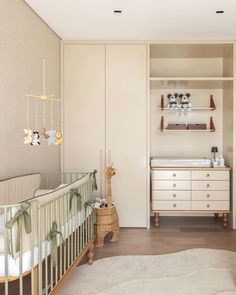 a baby's room with a crib, dresser and changing table in it