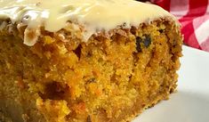 a close up of a piece of cake on a plate with a fork and napkin in the background