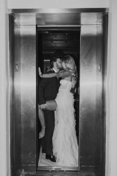 a man and woman kissing in an elevator