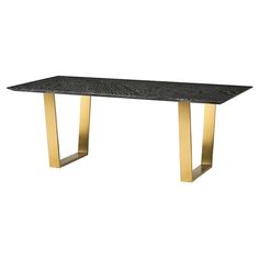 a black marble table with gold legs