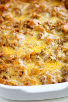 a casserole dish with meat and cheese in it sitting on a table top