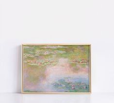 a painting hanging on the wall with water lillies in it's center and pink flowers at the bottom