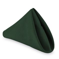 a green napkin folded up on top of a white surface