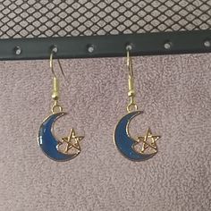 Blue Moon With A Gold Star On Nickel Free Gold Wires. New Without Tags Blue Crescent Moon Charm Earrings, Blue Moon-shaped Earrings With Moon Charm, Blue Moon Shaped Earrings With Moon Charm, Blue Moon-shaped Metal Jewelry, Blue Moon Charm Earrings, Blue Star Jewelry With Moon Charm, Blue Moon Shaped Celestial Earrings, Blue Celestial Moon Earrings, Celestial Blue Moon-shaped Earrings