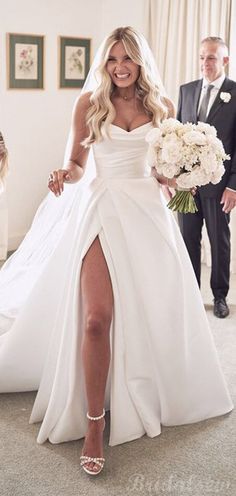 a woman in a wedding dress is walking down the aisle