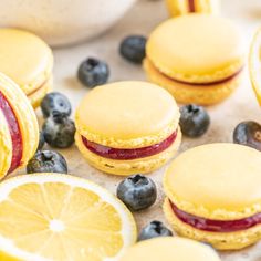 lemon sandwiches and blueberries are arranged on a table