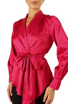 Lightweight satin makes elegance feel easy in this wrap top centered by a sweet bow. Front tie closure Surplice V-neck Long sleeves with button cuffs 100% polyester Hand wash, line dry Imported Wedding Swimwear, Satin Wrap Top, Magenta Top, Double M, Peplum Styling, Mob Dresses, Peplum Styles, Satin Material, New Arrival Dress