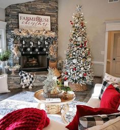 a living room decorated for christmas with white and red decorations