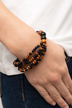 Stretchy strands of dainty brown and black wooden beads attach to a single strand of oversized brown and black wooden beads, resulting in colorful layers around the wrist.

Sold as one individual bracelet. Squirrel Jewelry, Black Order, Brown Bracelet, Wooden Bracelet, Wood Bracelet, Black Bracelet, Bracelet Online, Black Bracelets, Paparazzi Accessories