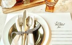 there is a place setting with silverware and napkins on the plate next to it