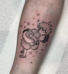 a small black and white tattoo on the leg of a person with a teddy bear