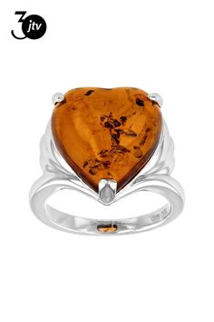 a heart shaped ring with an orange stone in the center