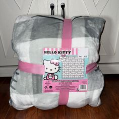 the hello kitty blanket has been wrapped in pink ribbon and is ready to be used as a pillow