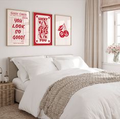 a bedroom with two posters above the bed