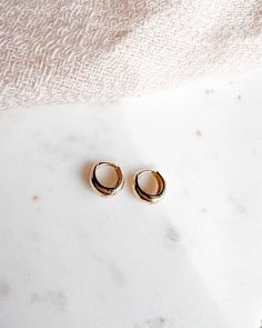 If you are looking for the best huggie earring that will hug your ear this is it! It is 10mm and runs pretty small but it fits right up against the ear with no space. This is all made from 14k Gold Fill and this tiny gold huggie hoop is great to pair with other earrings and fits great in a second or third piercing. DETAILS: -10mm (measured from outside to outside). Runs small, please keep in mind if you have larger earlobes. -14k Gold Filled -Chunky Style 14k Gold Fill: Gold fill is a pressure b Mini Gold Hoops, Graduation Earrings, Third Piercing, Gold Huggie Earrings, Huggie Earrings Gold, September Birthstone Rings, Great Graduation Gifts, Huggie Earring, Mom Ring