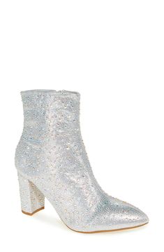 Instantly elevate any outfit with this dazzling side-zip bootie finished with a pointy toe and covered in a symphony of glittering crystals. 3 1/2" heel 5 1/4" shaft Synthetic upper, lining and sole Imported Glamorous Shimmer Boots With Pointed Toe, Silver Glitter Boots, Silver Pointed Toe Party Boots, Silver Pointed Toe Boots With Rhinestones, Silver Glitter Heel Boots, Silver Glitter Pointed Toe Boots, Pointy Toe Boots, Glitter Boots, Silver Glitter