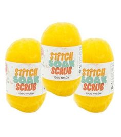 three yellow balls of soap sitting next to each other on a white background with the words stitch and scrub