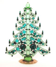 a green christmas tree made out of jewels