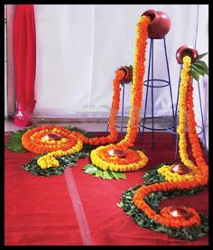 an arrangement of flowers and candles on the ground