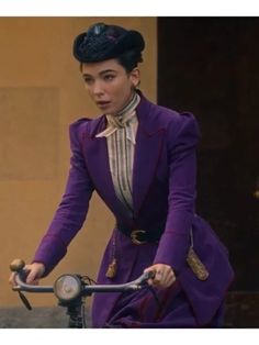 a woman in a purple suit riding a bike