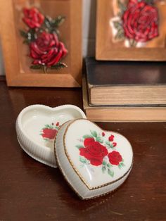 two heart shaped trinkets sitting on top of a table