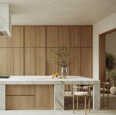 a kitchen with marble counter tops and wooden cabinets, along with an island in the middle