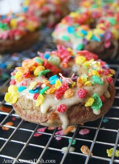 a close up of a doughnut with sprinkles on a cooling rack