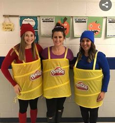 three girls in yellow aprons posing for the camera