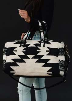 All our neutral lovers - this duffel is for you! Our restocked black and cream Aztec inspired duffel bag is a must have for all of your travels - big & small - this year!  Black and cream Aztec inspired duffel Zipper closure with interior zipper and 2 small open pockets Removable strap Measures 20" x 8" x 11" Designed in the U.S.A. Produced in India.  100% Cotton Lining: 100% Polyester Western Duffle Bag, Sac Week End, Duffel Bags, Travel Duffel, Duffel Bag Travel, Black And Cream, Aztec Print, Looks Style, Duffel Bag