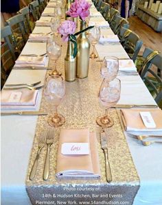 the table is set with pink flowers and place settings