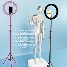 a white mannequin standing in front of a ring light