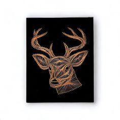 an embroidered deer head on a black background