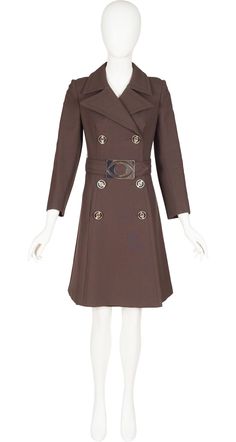 "This 1960s mod double-breasted brown wool coat is missing its designer label, but it's the same high quality that you would see from Cardin or other influential designers of the era. It has large pointed lapels, a pocket on each side, and a 22\" vent in the back. The belt has a large silver-tone metal buckle in the shape of an eye. It fastens with silver plastic round buttons, and has three matching decorative buttons on each cuffs. There are a few minor scratches on the belt buckle but the coat is otherwise in excellent condition, professionally dry-cleaned and ready to wear. Measurements: Bust - 32\" Waist - 29\" Hips - 34\" Shoulders - 14.5\" Sleeves - 20.5\" Length - 37\" IMPORTANT NOTE FOR CANADIAN SHOPPERS: There is a 15% shipping fee that is automatically applied to Canadian orders Formal Brown Wool Coat With Double Button Closure, Formal Brown Wool Coat With Double Button, Luxury Brown Pea Coat With Button Closure, Brown Double-breasted Wool Coat With Double Button, Brown Double-breasted Wool Coat, Elegant Brown Double-breasted Outerwear, Brown Luxury Double-breasted Pea Coat, Brown Wool Coat With Double-breasted Buttons For Business, Fitted Brown Wool Coat With Double Button Closure