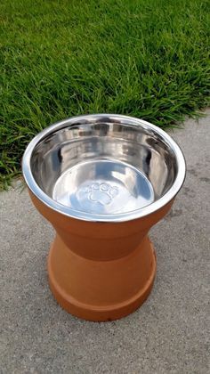 a metal bowl with a paw print on it