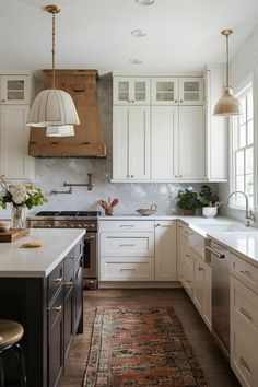 a kitchen with white cabinets and an area rug