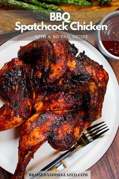 grilled chicken on a plate with asparagus and ketchup next to it