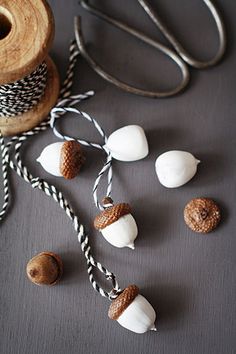 some white and brown items are on a table next to twine spools