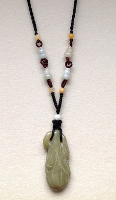 The jade will bring good luck/fortune and protect the wearer. This lovely and graceful carved Vintage Hand-Carved Nephrite jade stone  blossom pendant measures 2 1/8" long.  It is strung on a hand knotted black cord with jade beads. Jade Bead Necklace, Hand Knotted Necklace, Blown Glass Pendant, Nephrite Jade, Jade Necklace, Antique Necklace, Jade Carving, Jade Stone, Jade Beads