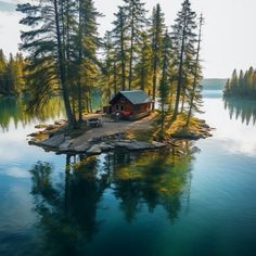 an island in the middle of a lake with a cabin on it's side