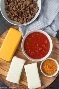 cheese, meat and sauce on a wooden plate