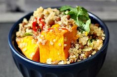 a blue bowl filled with rice and vegetables