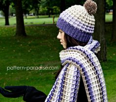 a woman wearing a blue and white crocheted scarf