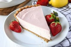 a slice of strawberry cream pie on a plate with strawberries