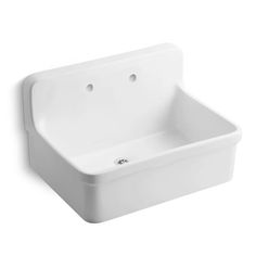 a white sink sitting on top of a wall